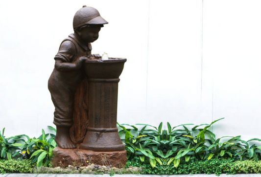 Boy Leaning Over Water Fountain with LED Light