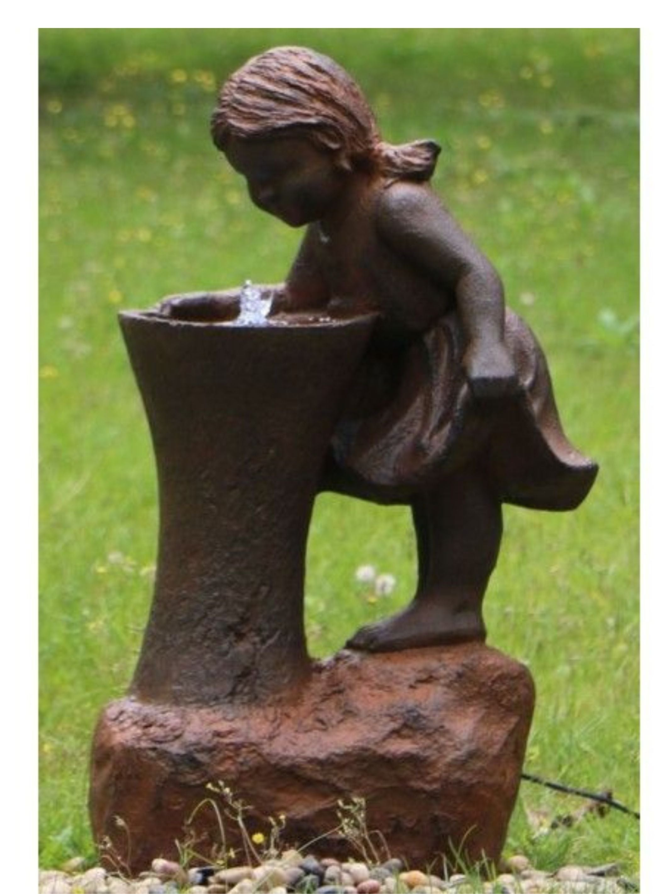 Young Girl Leaning Over Water Fountain with LED Light